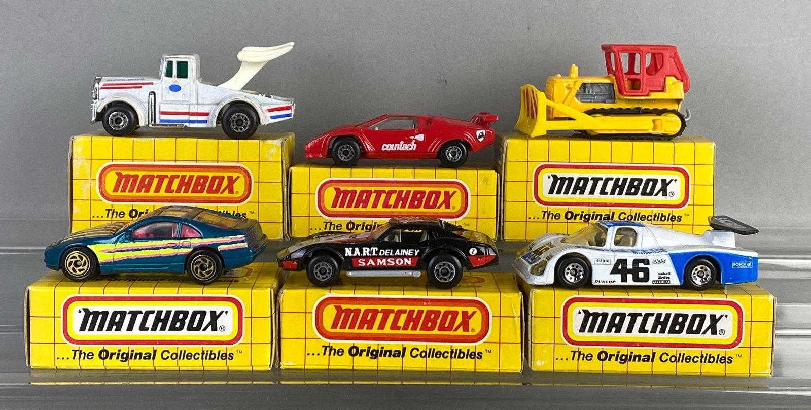 Group of 6 Matchbox Die-Cast Cars: Includes No. 62 Chevy corvette, No. 61 Nissan 300-zx, No. 64 bulldozer and more, with boxes