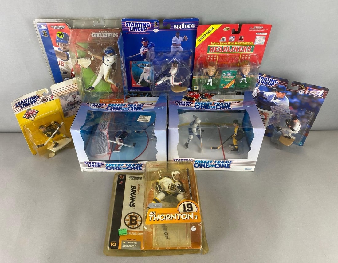 Group of 8 Collectible Sports Figurines: All are sealed. Some yellowing of plastic. Includes Joe Thornton, Cam Neely, Manning and more. Largest box measures 6 1/2 x 10 x 7 1/2 inches.