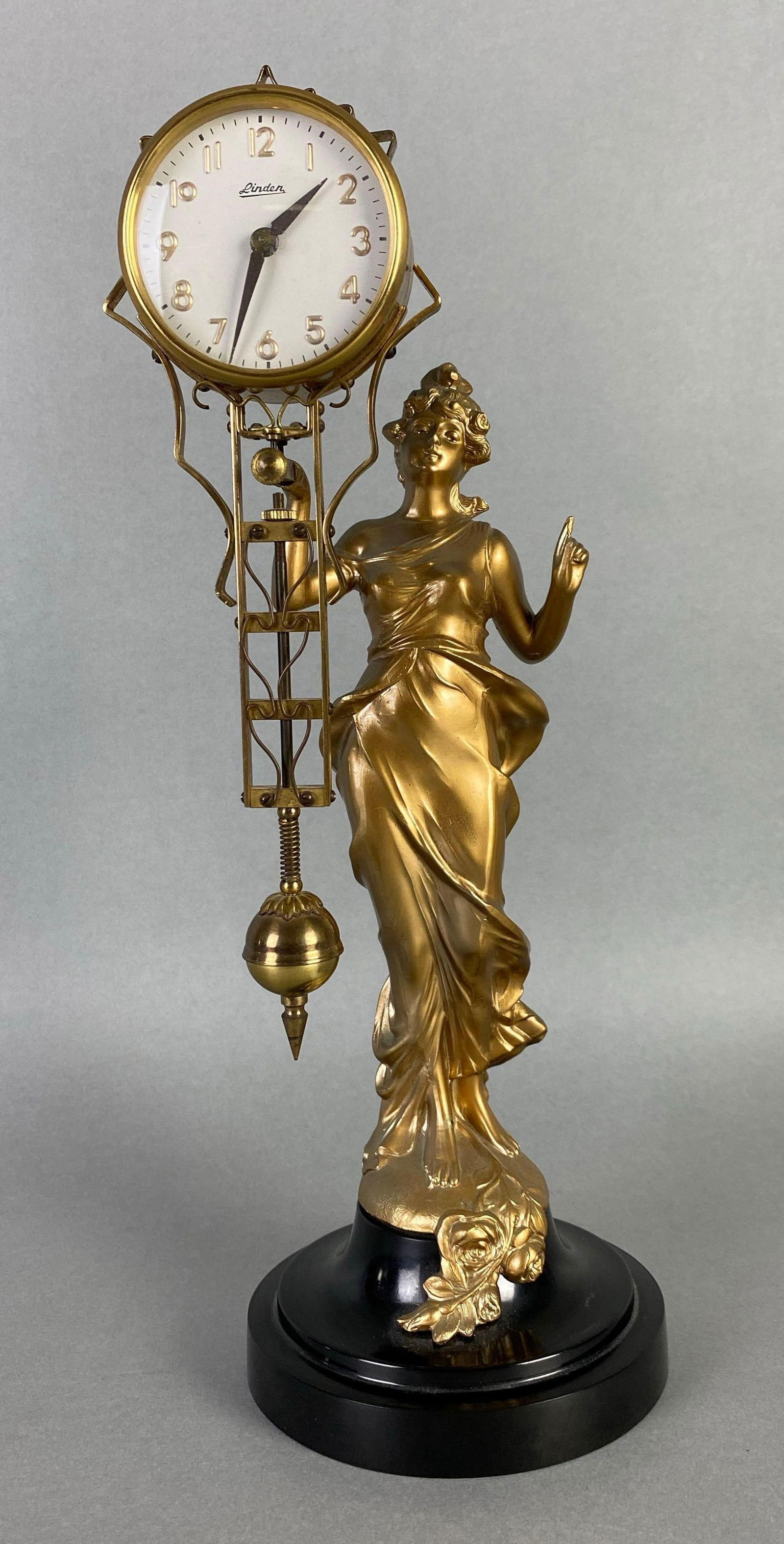 Linden Japanese Swinging Diane Figural Clock: in working condition, measures 13 1/2 x 5 1/2 x 6 inches