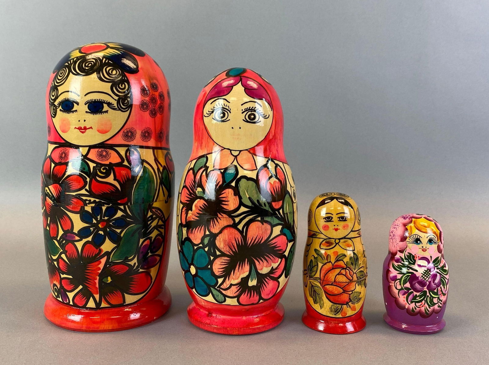 Group of 4 Hand-Painted Matryoshka Russian Nesting Dolls: Tallest measures 9 1/2 inches tall