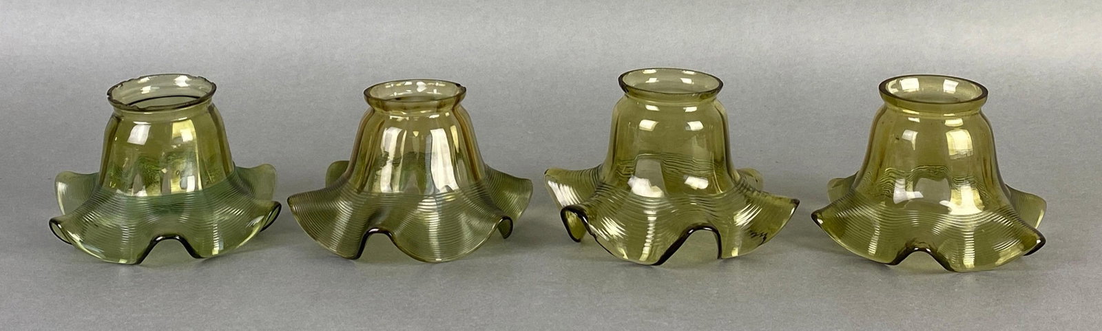 Group of 4 Antique Olive Ruffled Applied Spiral Glass Lamp Shades: Some chips throughout fittings, tallest measures 3 1/2 x 5 1/4 inches, fitter measures 2 1/4 inches