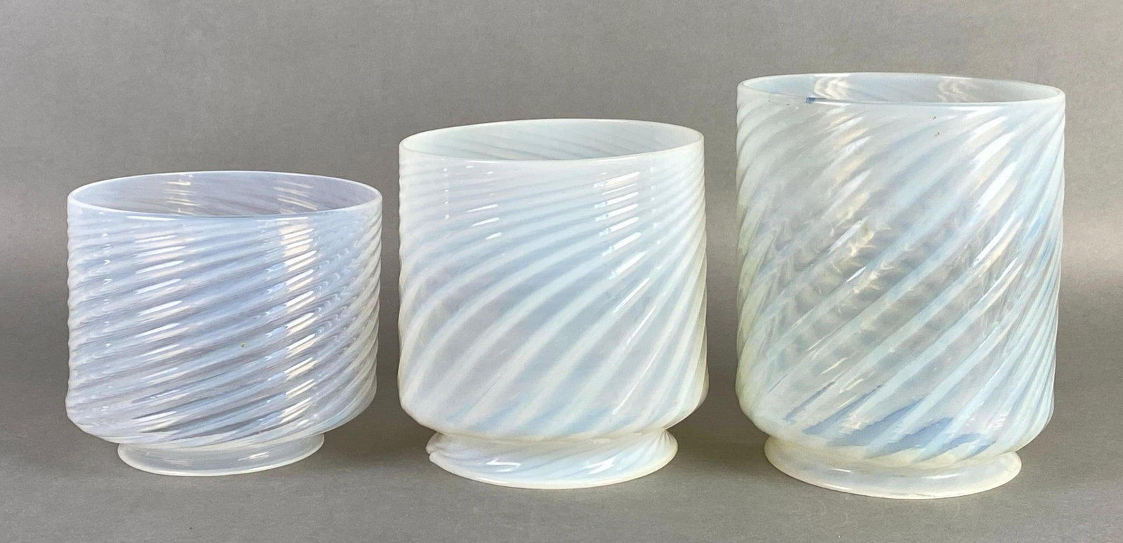 Group of 3 Antique Opalescent Spiral Glass Lamp Shades: Middle shade glows under UV light, large crack in middle shade, largest measures 7 x 6 inches, fitter measures 4 3/4 inches