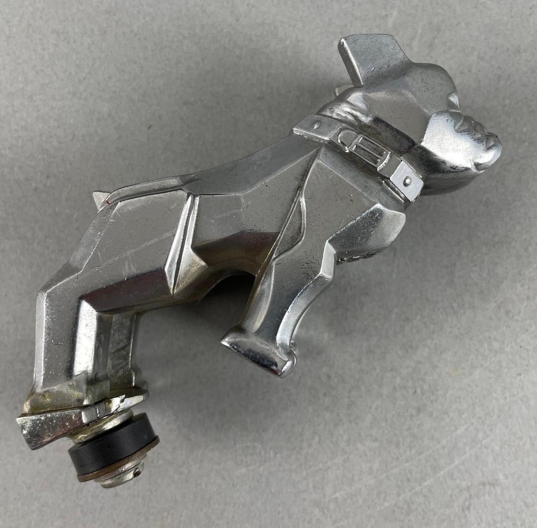 Vintage Mack Truck Bulldog Hood Ornament: Is cracked on bottom and is yellowing. Measures 2 1/4 x 1 1/2 x 3 1/2 inches.