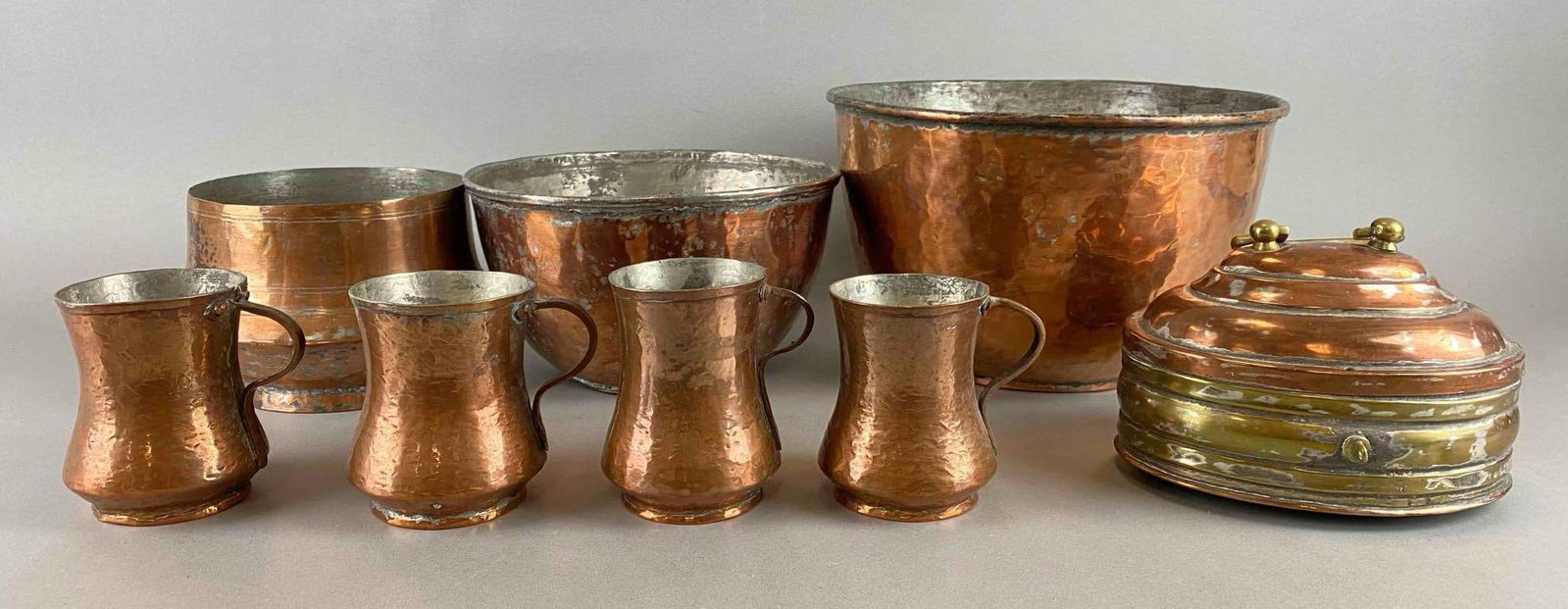 Group of 8 Copper Finished Items: Includes Cup, mixing bowl, serving bowl and more. Chest has brass on it. Largest item measures 7 x 10 1/2 x 10 1/2 inches.