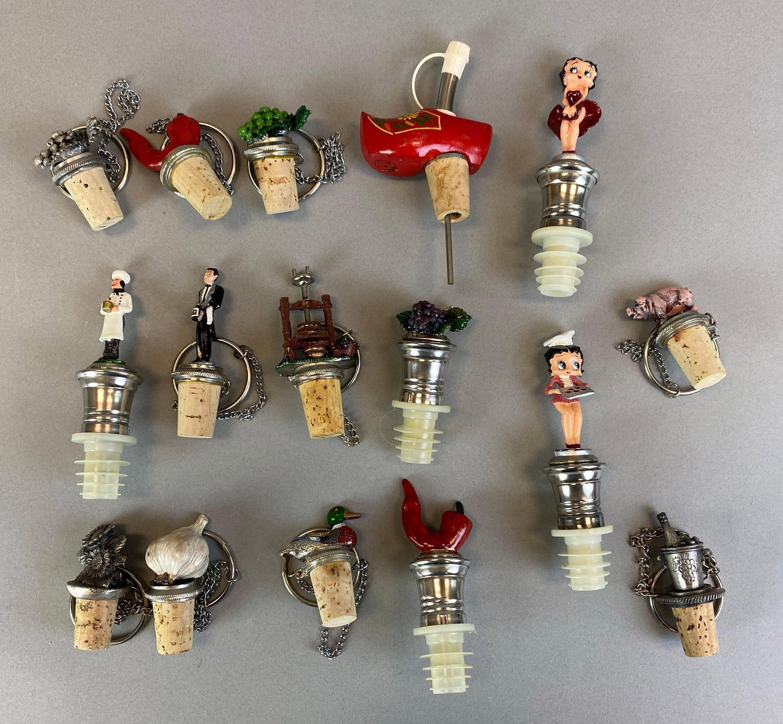 Group of 16 Decorative Bottle Stoppers: Includes Betty Boop, Chilli pepper, butler and more, largest measures 5 1/4 inches tall