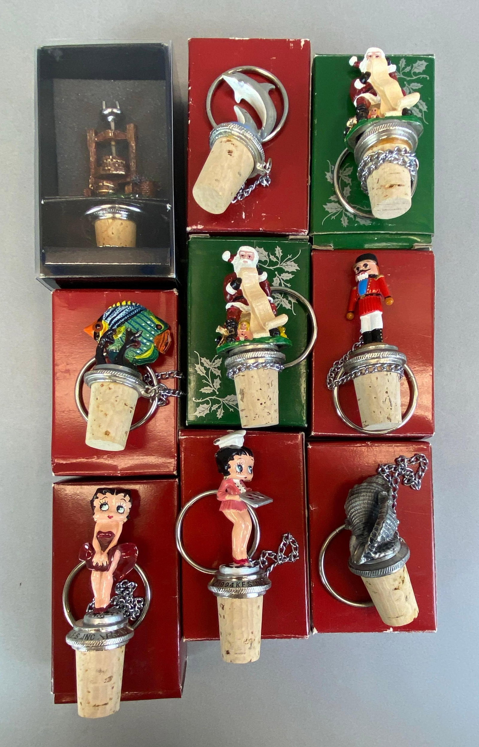 Group of 9 Decorative Painted Wine Corks: All with original boxes, largest measures 4 inches tall
