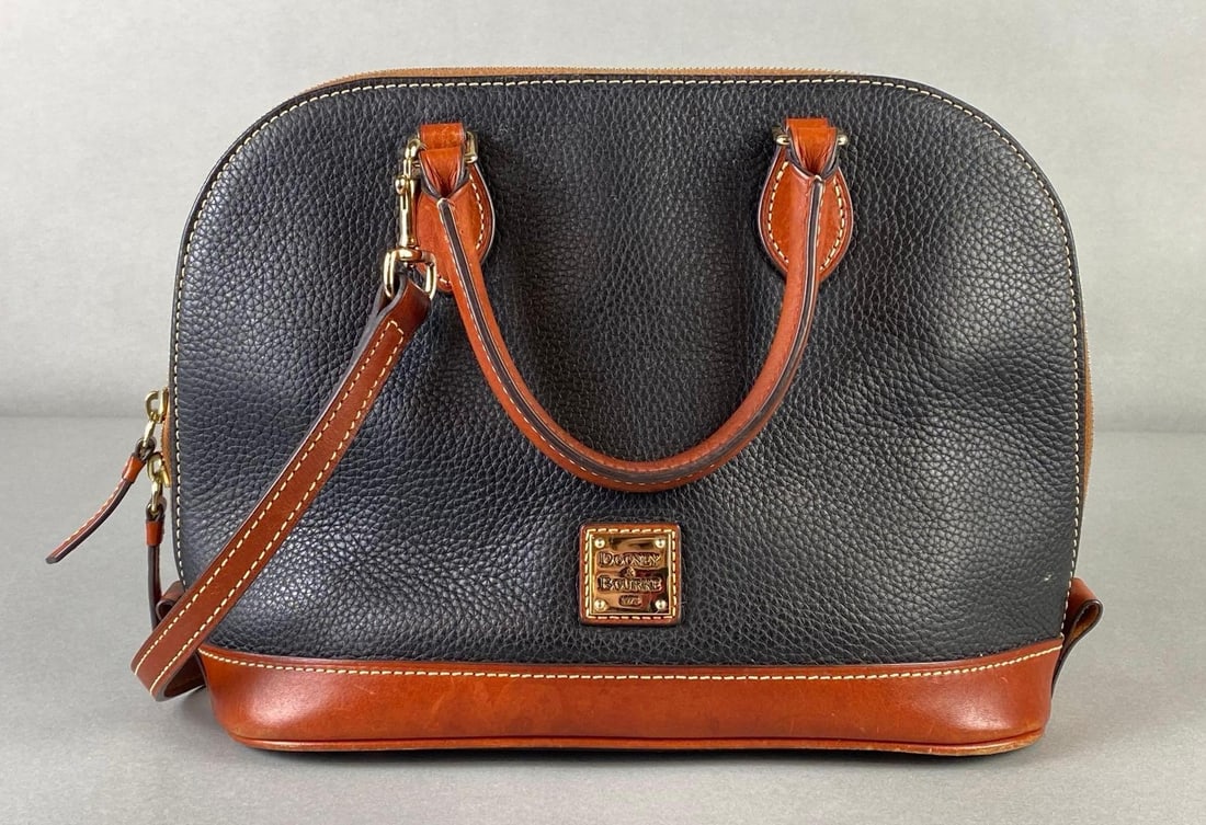Dooney and Bourke Black and Brown Leather Purse: With dust bag, Some staining on inner lining, Purse body measures 9 x 13 x 5 1/4 inches.
