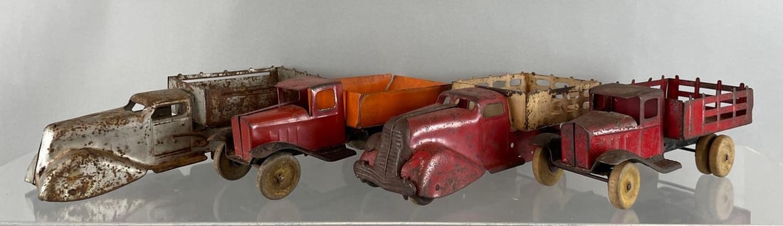Group of 4 Vintage Pressed Steel Trucks with Wood Wheels: Silver dump truck missing front wheels, includes Marx, possibly Wyandotte. Largest measures 3 1/4 x 11 x 4 inches