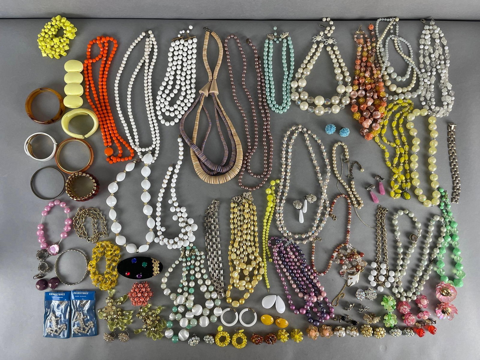 Group of 90+ Beaded Costume Jewelry: Includes clipon earrings, necklaces, bracelets. Longest measures 54 inches