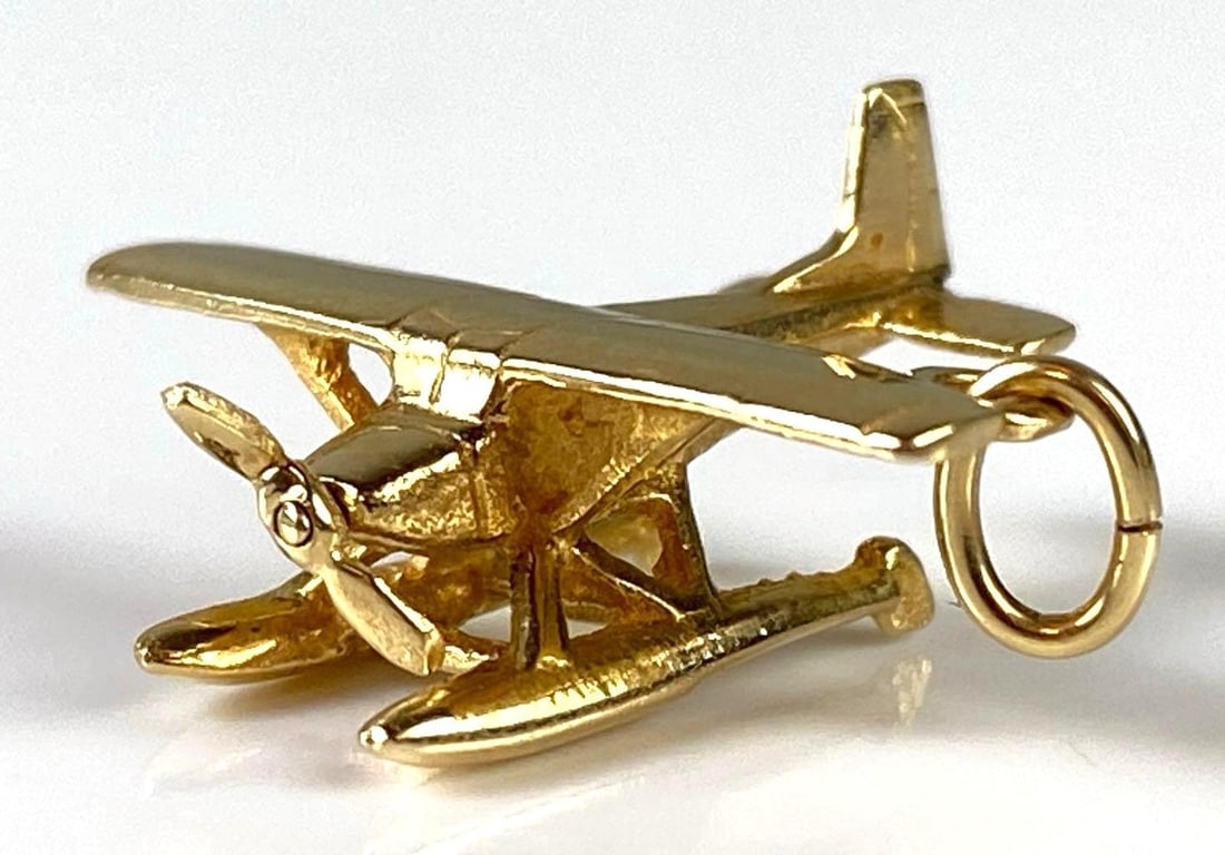 14K Gold Propeller Plane Charm: Total weight 2.5g, One propeller bent, Measures 3/4 x 1 inch.