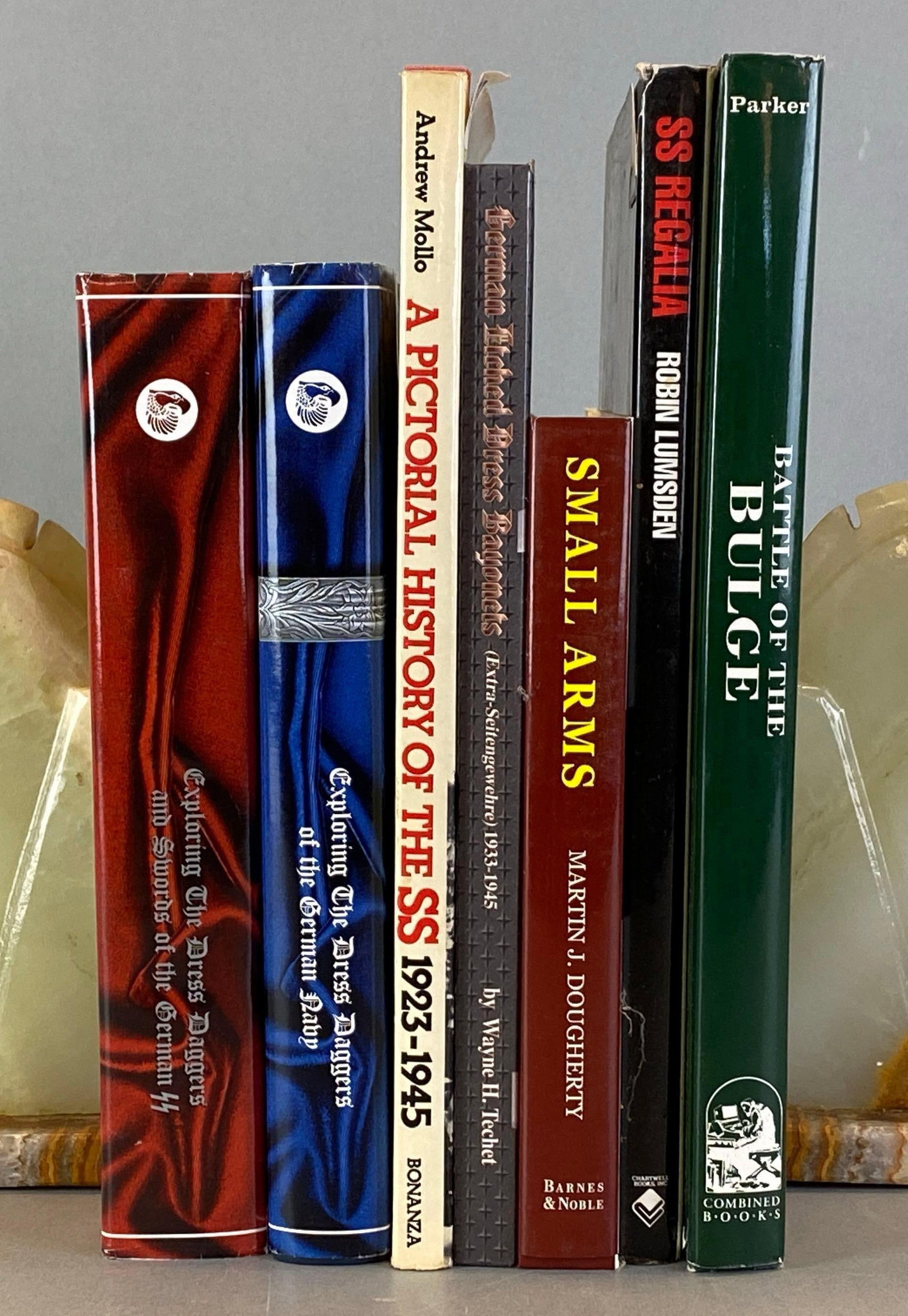 Group of WW2 German Hardcover Books and More: Includes The Battle of The Bulge, Exploring the dress daggers if the German navy, A pictorial history of the SS and more, largest measures 12 1/2 x 9 inches