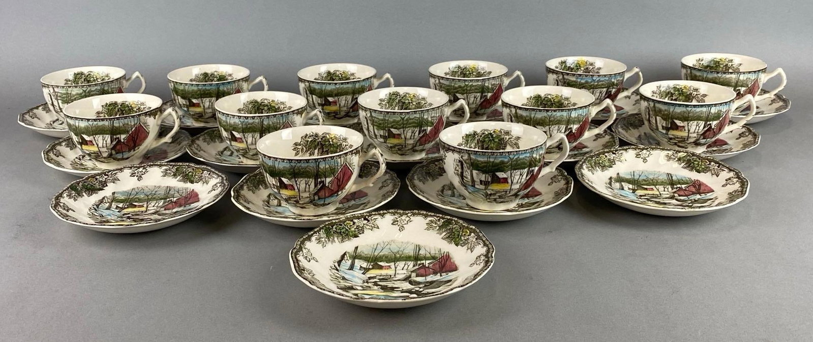 The Friendly Village The Icehouse by Johnson Bros Porcelain Teacups and Saucers: Made in England. Includes 13 teacups and 16 Saucers. Teacup measures 2 1/2 x 4 1/2 x 3 1/2 inches.