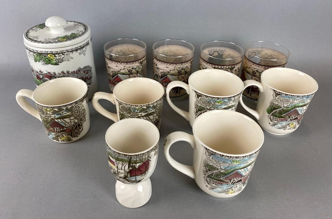 Group of Assorted The Friendly Village by Johnson Bros Drink Ware and More: Made in England. Includes an eggcup, small Canister, mug and more. Largest item Measures 6 1/2 x 4 3/4 x 4 3/4 inches.
