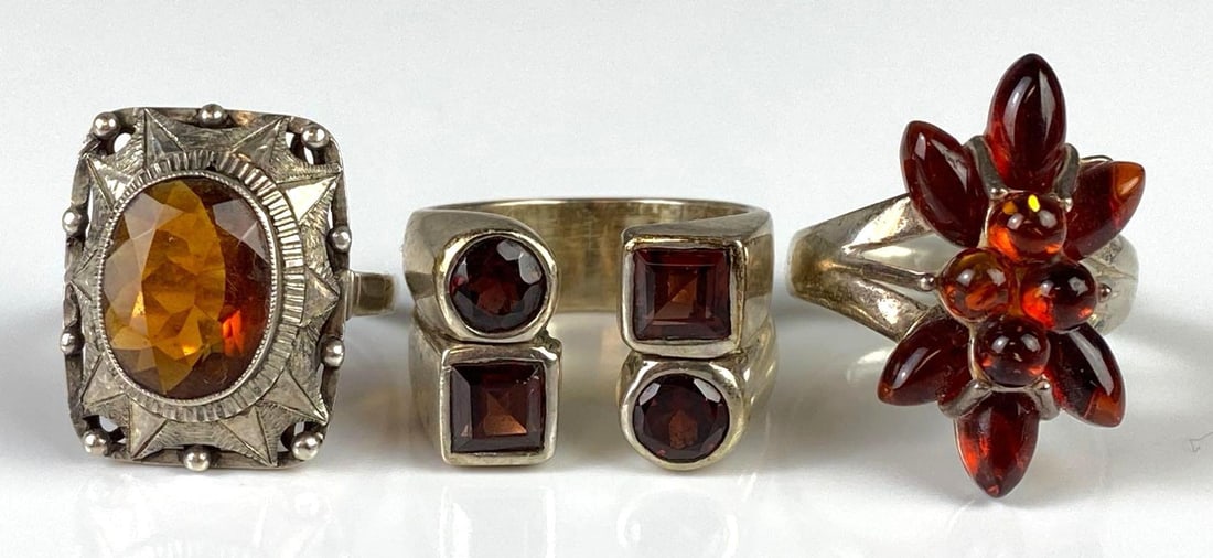Group of 3 Sterling Silver Garnet and Amber Rings: Sizes include 6 3/4, 8 1/4, and 8 1/2.