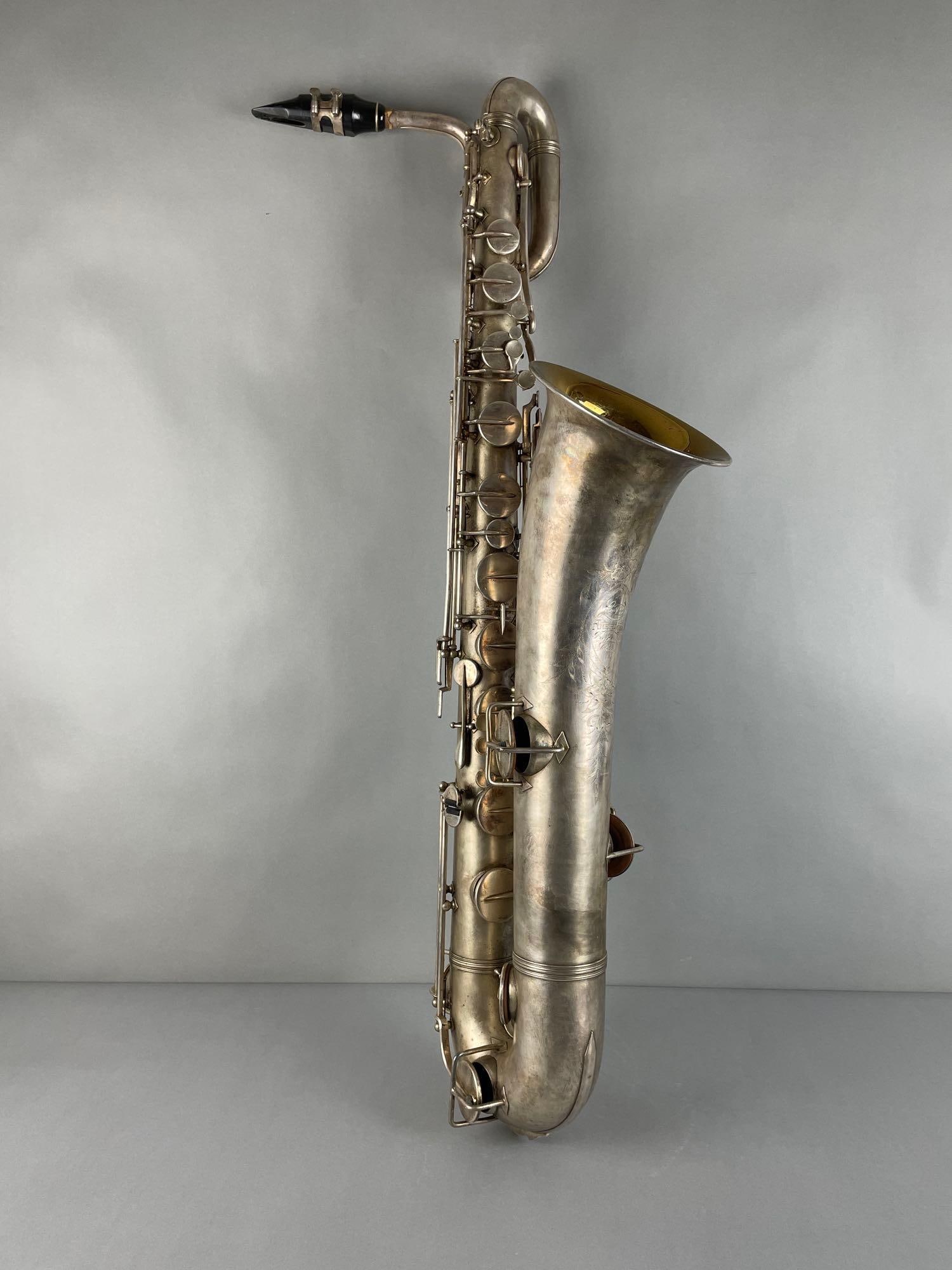 Vintage Lyon and Healy American Baritone Saxophone with Case: Serial number 39834, Pat. 1914. Sax measures 40 1/2 inches, case missing handle, measures 9 x 42 x 15 inches