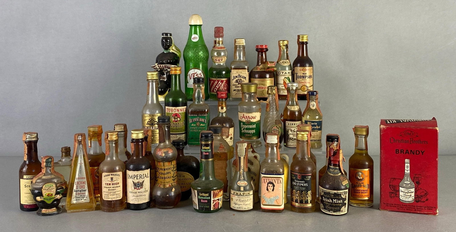 Group of Vintage Miniature Spirit Bottles: Includes Old Grand-Dad, seagrams, Jim bean and more, mix of empty to full bottles, largest measures 6 1/2 inches tall