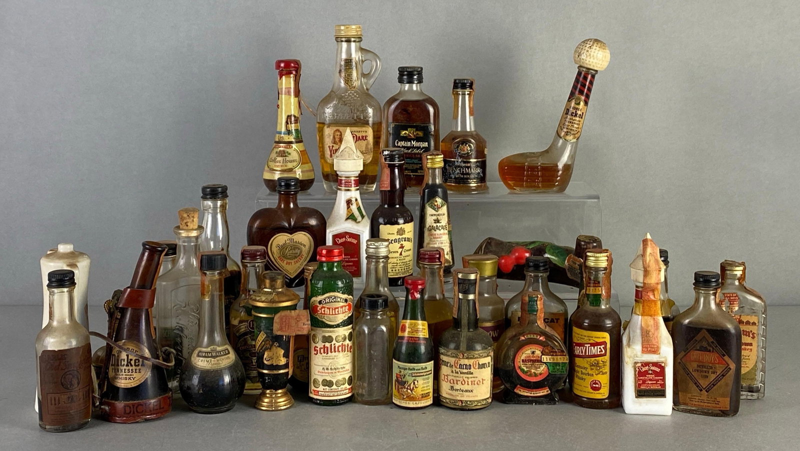 Group of Vintage Miniature Spirit Bottles: Includes George Dickel, Captain Morgan, Seagrams and more, mix of empty to full bottles, largest measures 6 inches tall