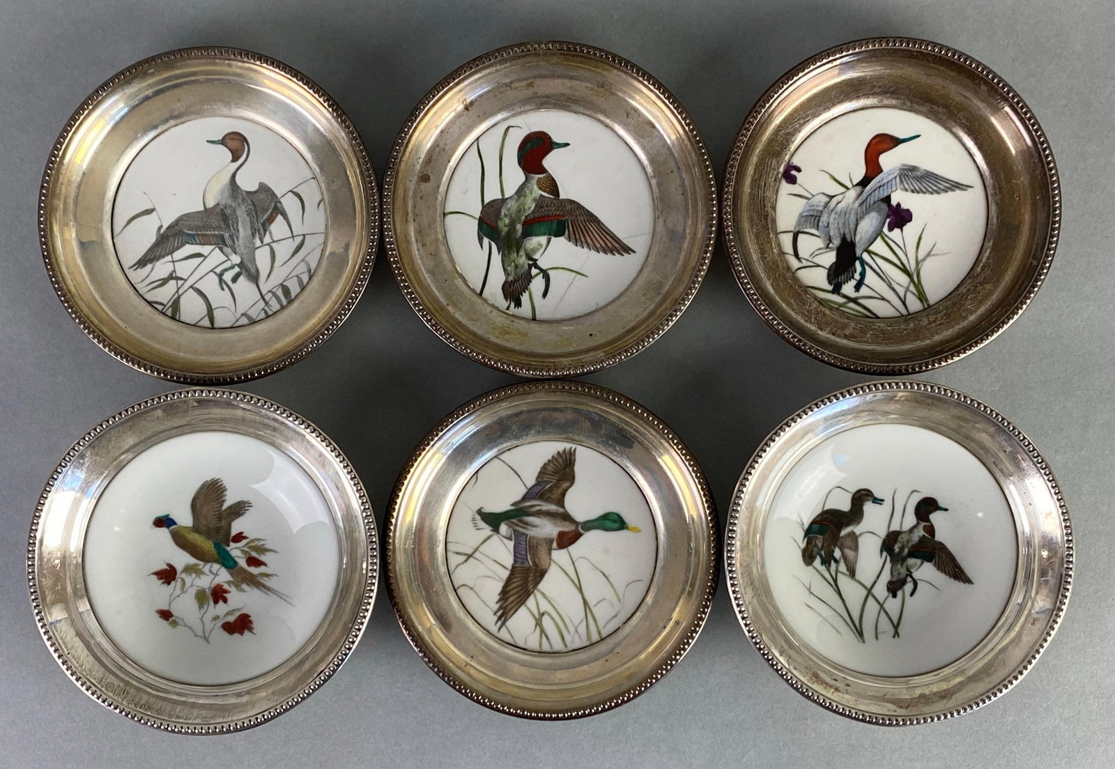 Group of 6 Frank M Whiting Hand Colored Bird Porcelain Bowls: features sterling silver rims, all marked on base, one bowl cracked, largest measures 4 1/2 x 1 1/4 inches