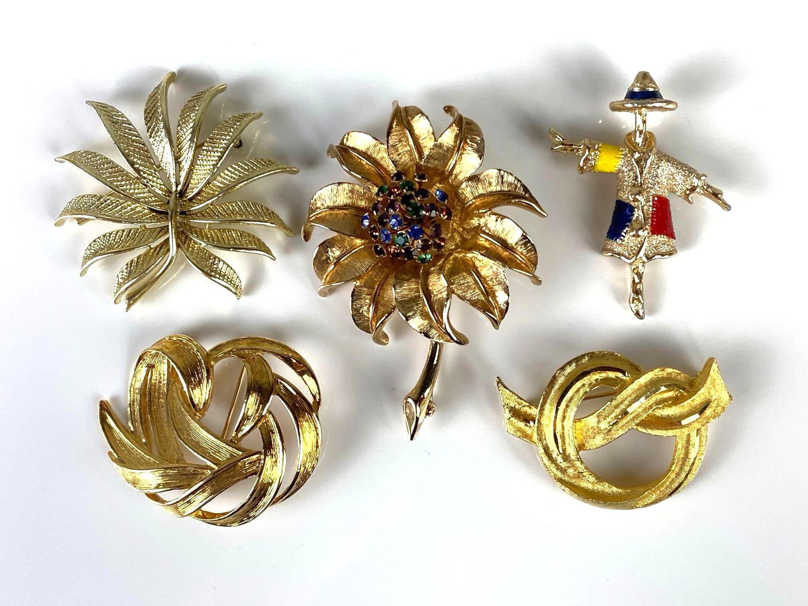 Group of 5 Costume Jewelry Brooches: Includes Monet, Judy Lee, Coro, BSK, and Sarah Coventry, Largest measures 3 x 2 1/4 inches.