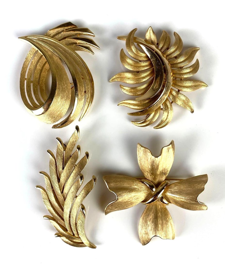 Group of 4 Trifari Costume Jewelry Brooches: Largest measures 2 1/4 x 2 inches.