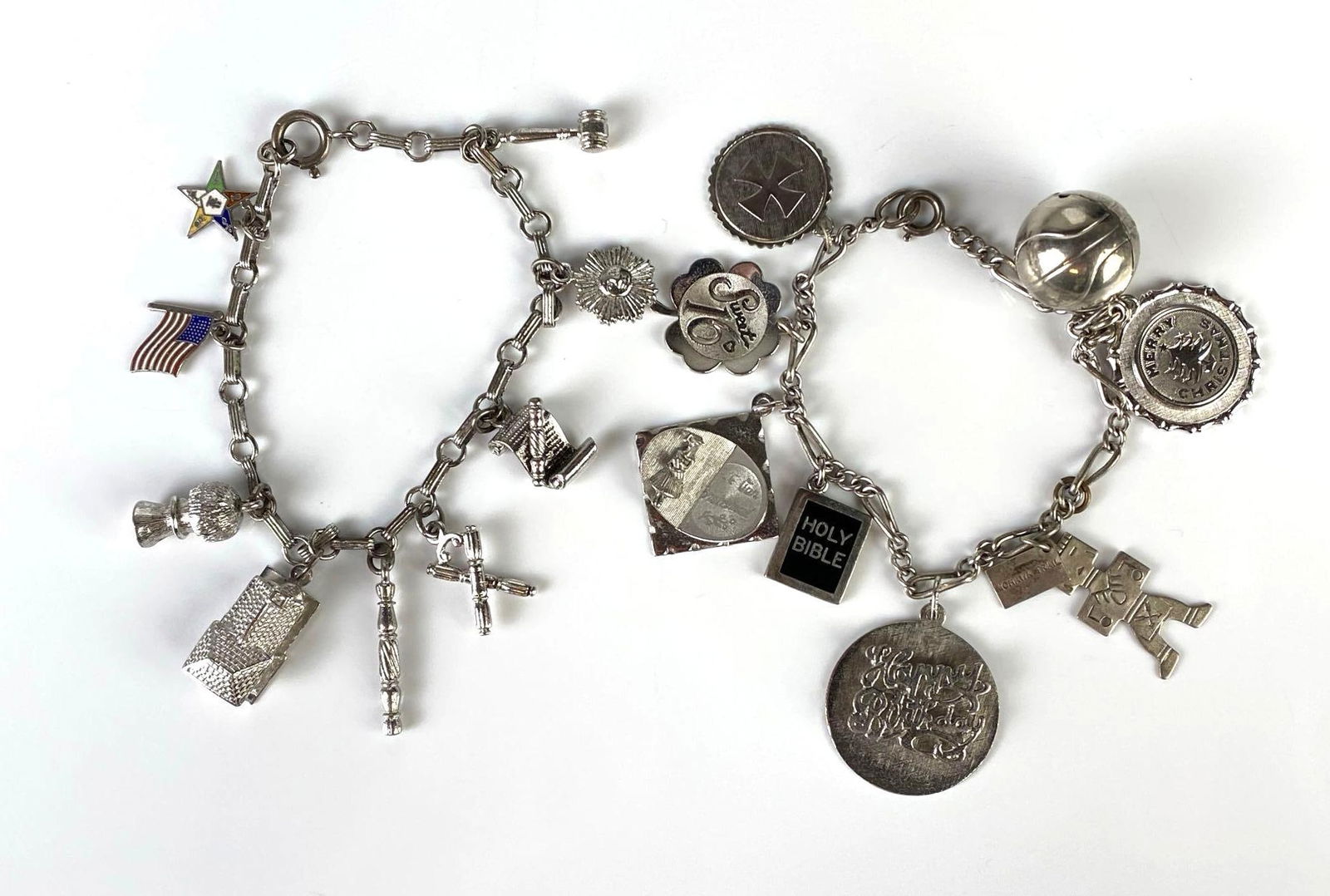 Group of 2 Sterling Silver Charm Bracelets: Total weight 55.5g, One with 8 charms, One with 9 charms, Charms include Happy Birthday, Sweet 16, gavel, flag, and more, Longest bracelet measures 7 1/2 inches long.