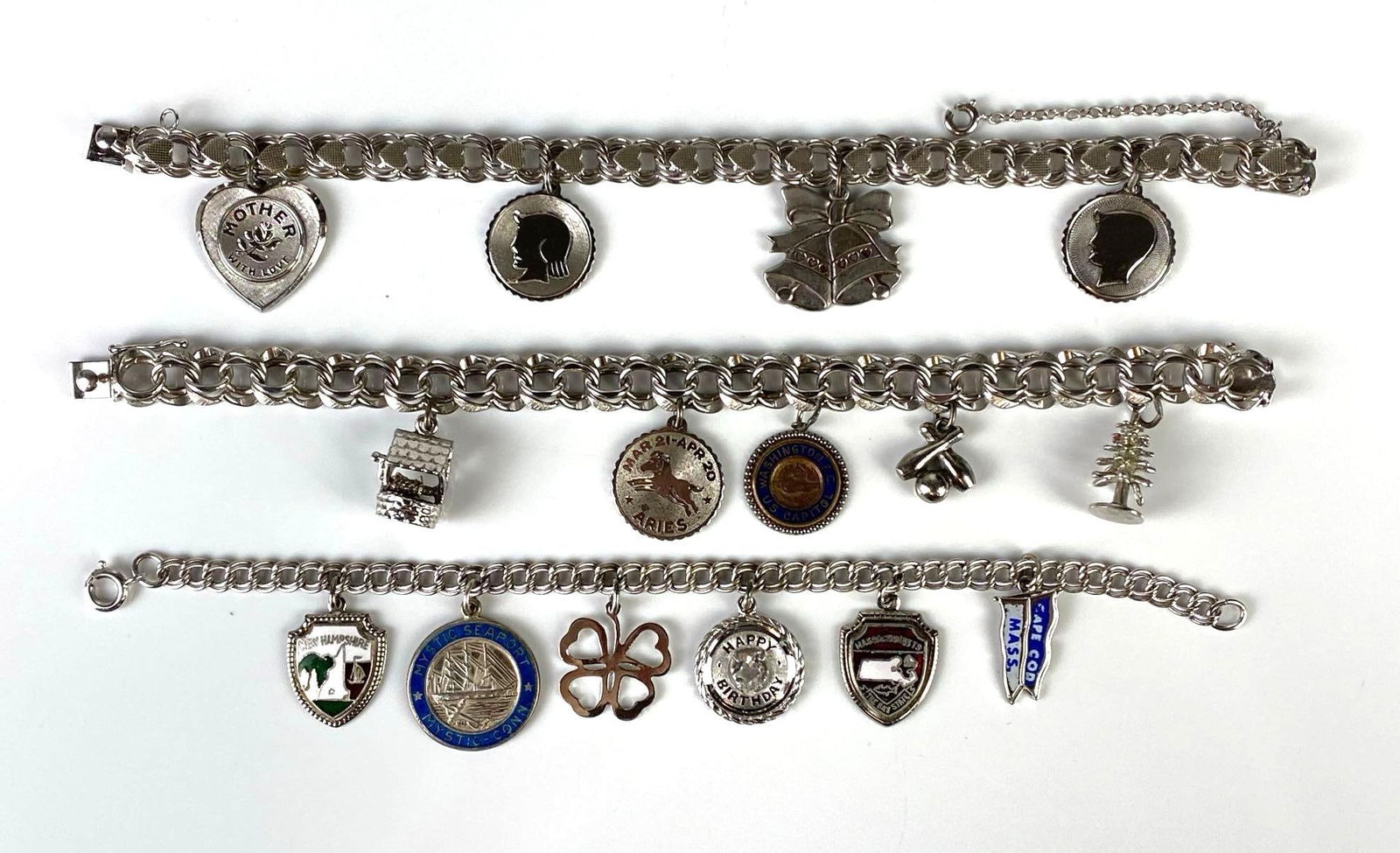 Group of 3 Sterling Silver Charm Bracelets: Total weight 79.5g, Sterling silver bracelets with sterling charms, Includes Mother, Aries, wishing well, and more, Longest bracelet measures 7 1/4 inches long.