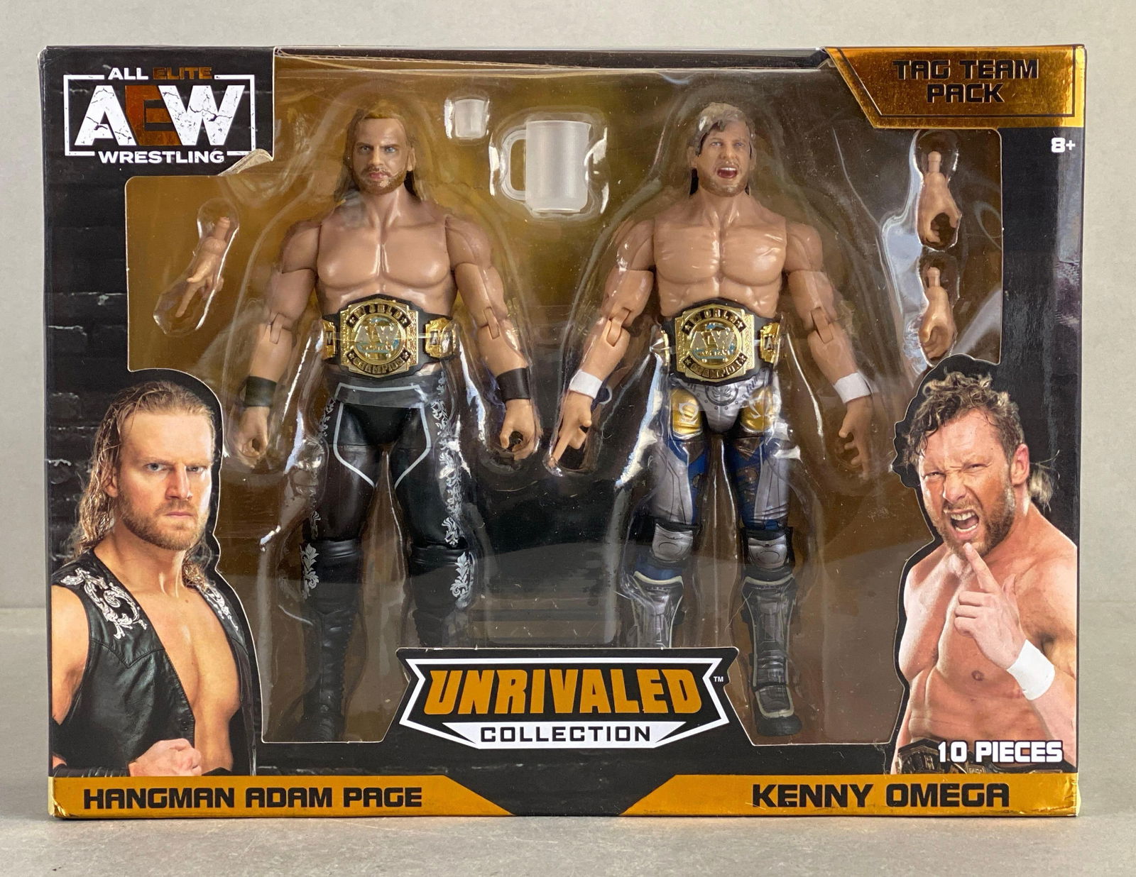 2021 AEW Unrivaled Collection Action Figure Pack: Tag team pack, all elite wrestling, includes hangman Adam page and Kenny Omega, sealed like new, measures 8 x 11 x 2 1/2 inches