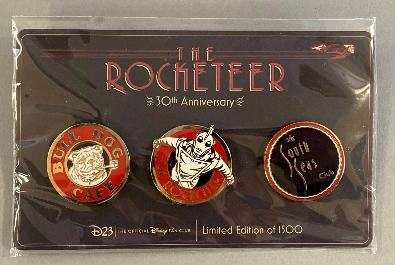 Group of 3 The Rocketeer 30th Anniversary Enamel Pins: Limited Edition of 1500. Largest pin measures 1 1/2 x 1 1/2 inches.
