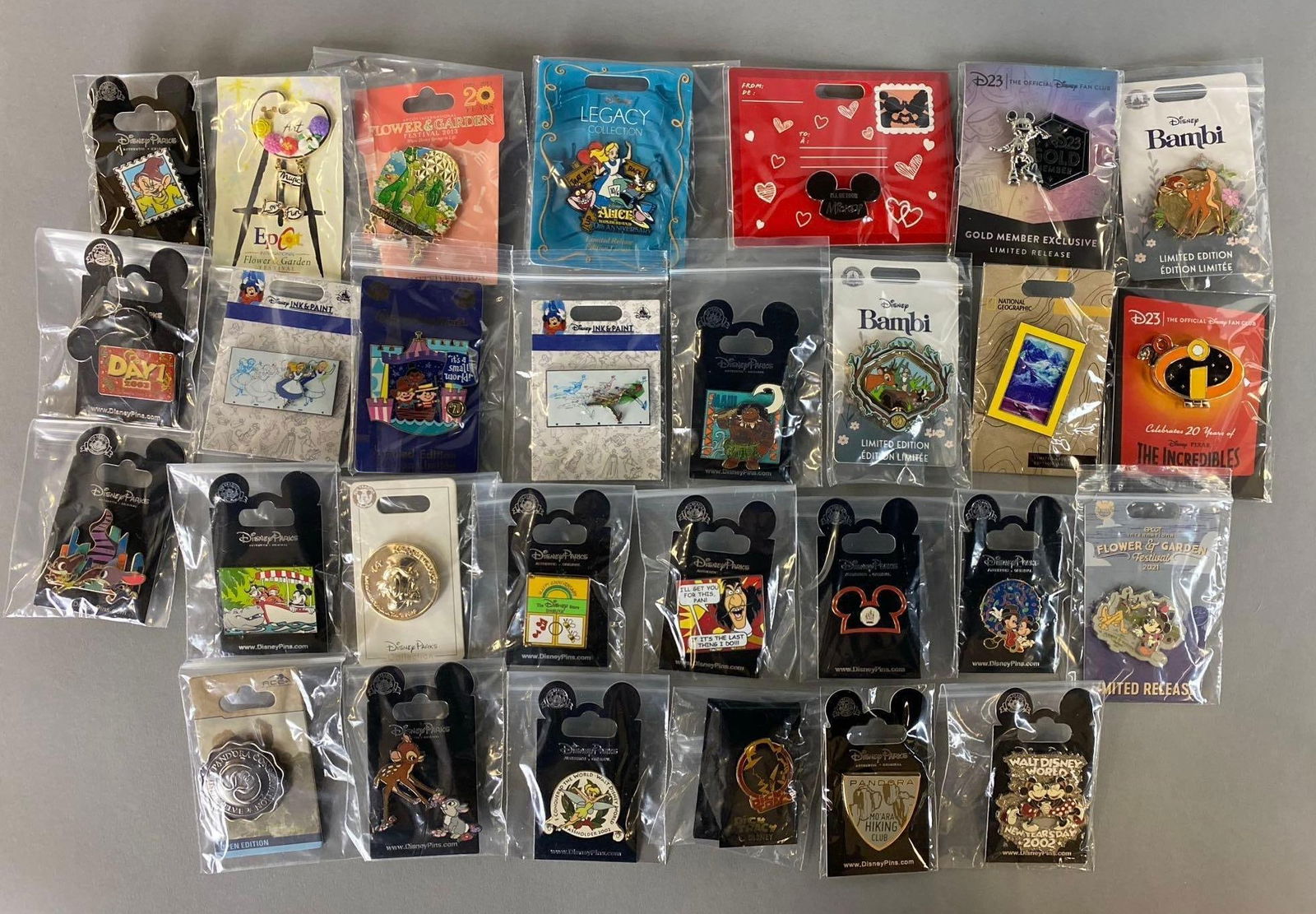 Group of 29 Disney Enamel Pins: Includes Limited Edition, Limited Release and Open Editions. Features Alice in Wonderland, Goofy, International Flower And Garden and more. Largest pin measures 2 1/2 x 1 3/4 inches.