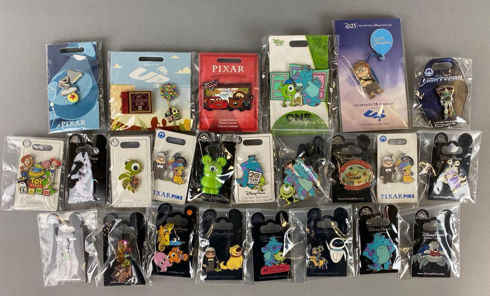 Group of 31 Disney Enamel Pins: Includes Limited Edition amd Limited Release pins. Features Up, Monsters INC, Wall E and more. Largest pin measures 3 x 2 inches.
