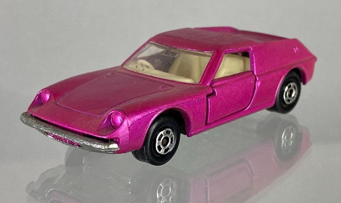 1969 Matchbox No. 5 Lotus Europa: Issue date 1969, A Lesney Product, Die-Cast, Pink body, Cream interior, Clear window, Silver base, Black plastic wheels, Made in England.