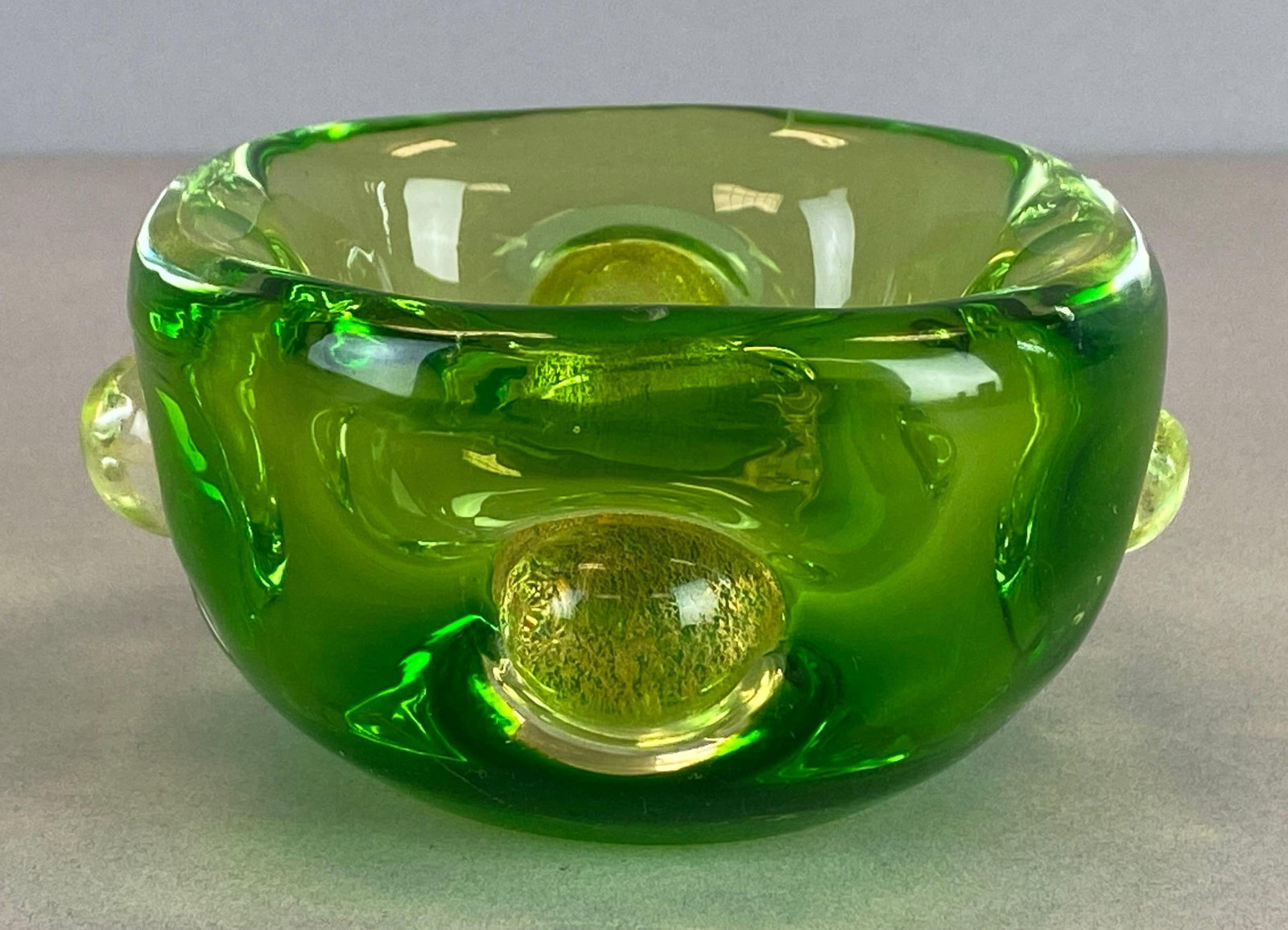 Mid-Century Modern Murano Style Green Art Glass Bowl: Features applied gold flake glass orbs, Measures 2 1/2 x 5 x 5 inches