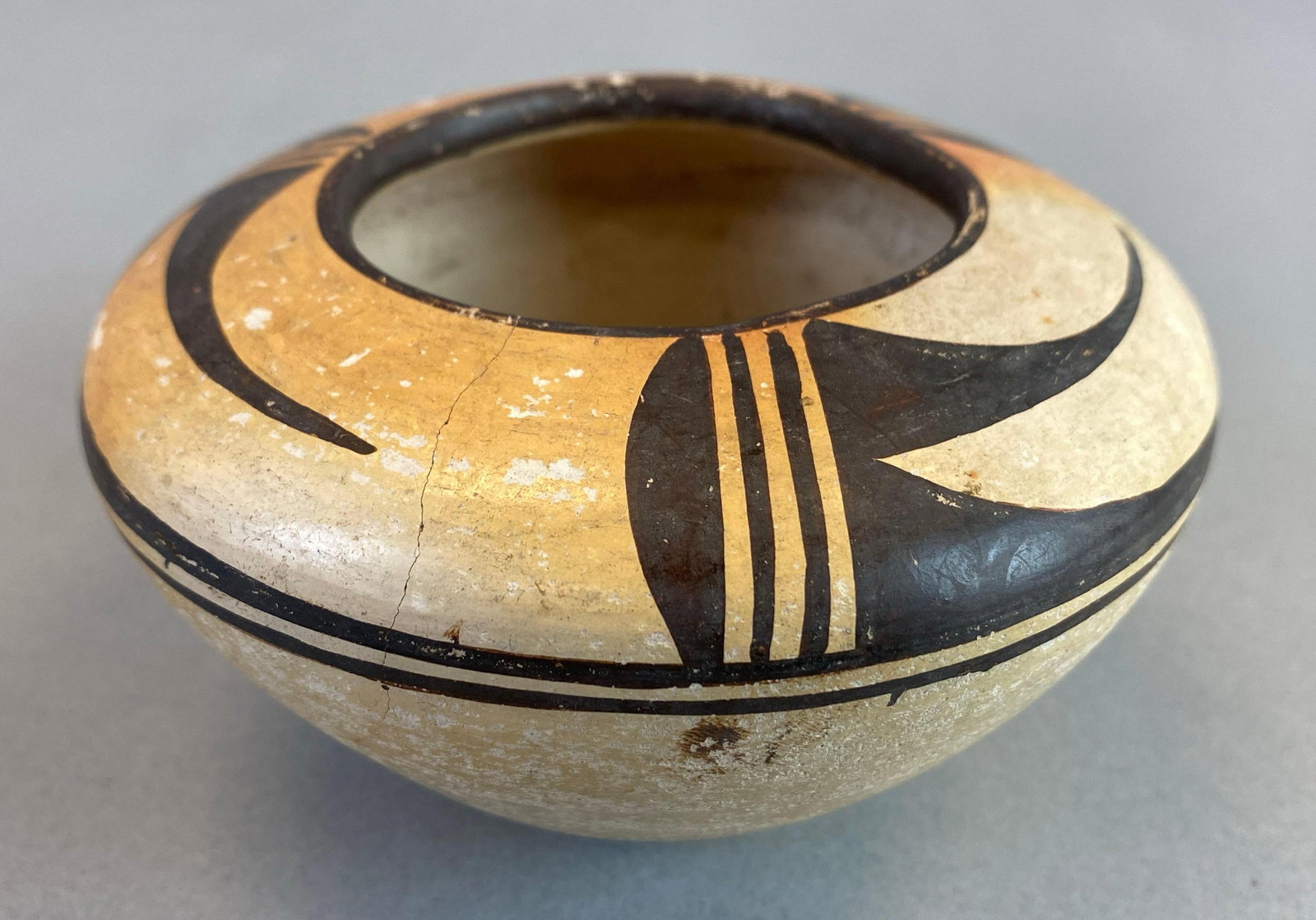 Native American Hopi Pottery Bowl: Large hairline crack leading from rim into wall of bowl, measures 2 1/2 x 4 1/4 inches