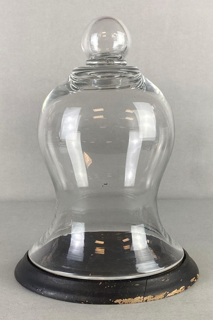 Antique Uniquely Bell Shaped Glass Cloche with Base: Base slightly larger than rim of cloche,Small crack across wood base, Measures 13 x 9 1/2 x 9 1/2 inches together.