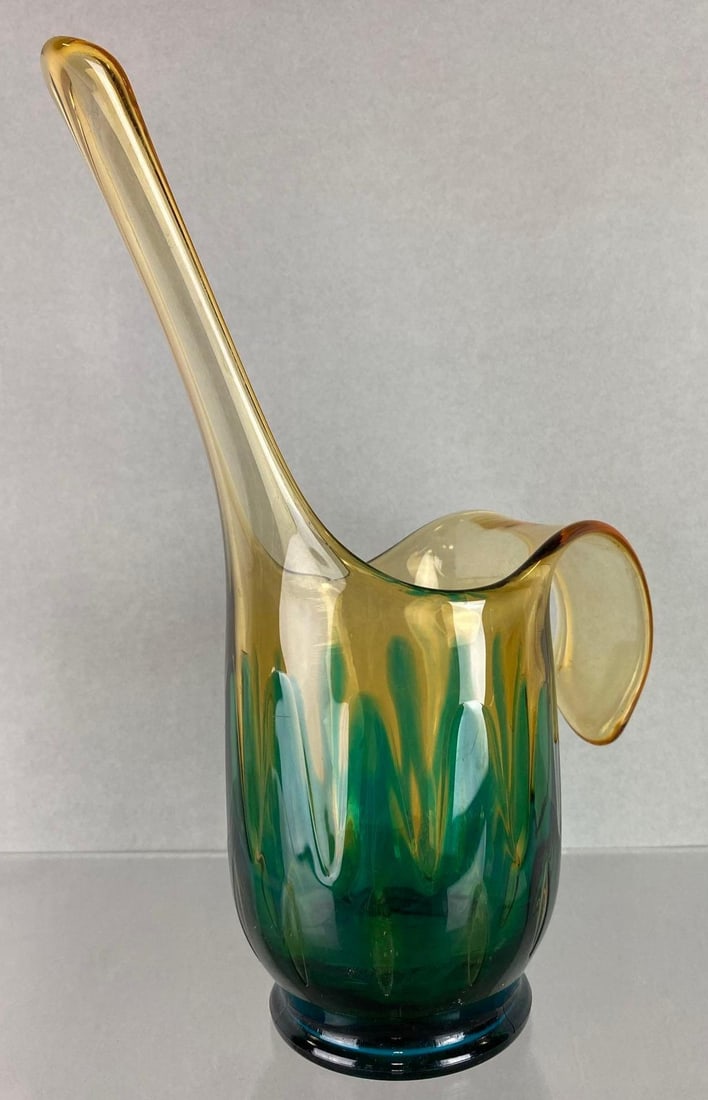 Mid Century Modern Art Glass Pitcher: Needs cleaned. Amber and teal. Measures 10 x 7 1/2 x 3 1/2 inches.