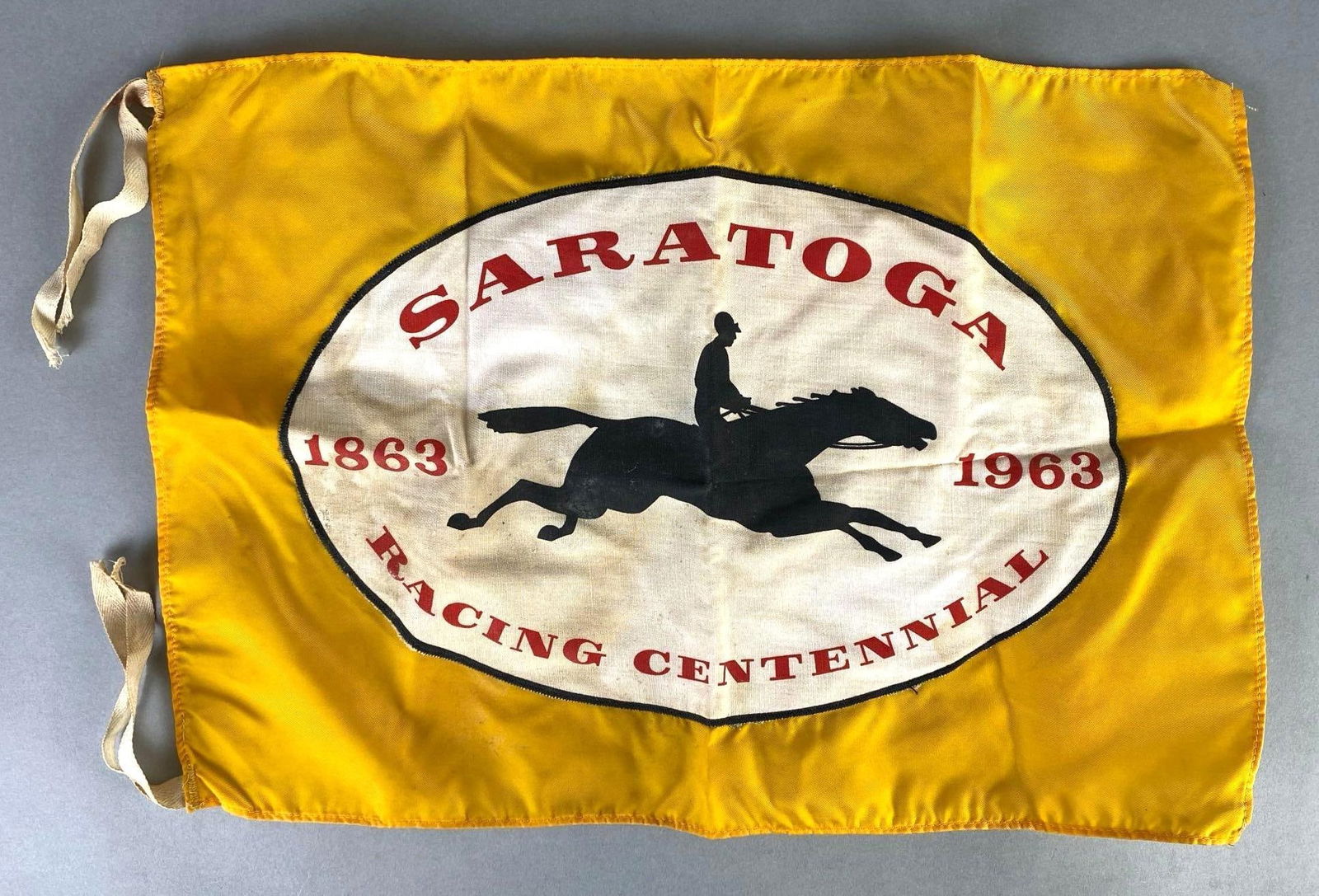 1963 Saratoga Racing Centennial Flag: Some staining, Measures 12 x 17 inches.