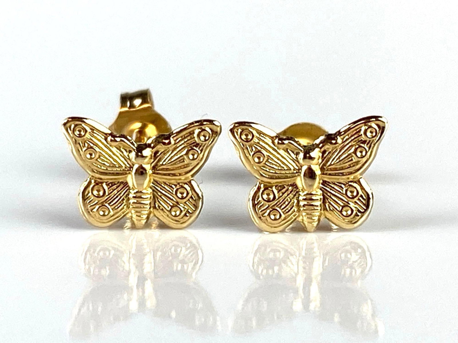 Pair of Small 14K Gold Butterfly Stud Earrings: Total weight 0.3g, Both measure 1/4 inch diameter wide.