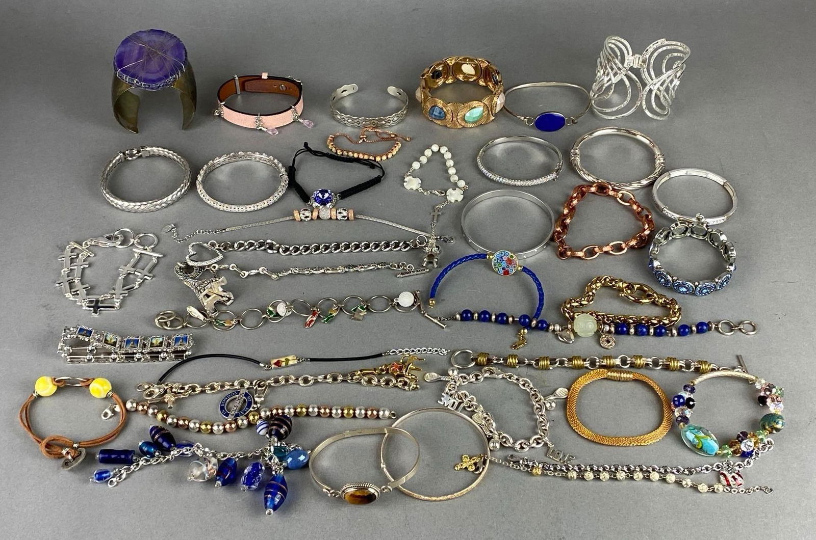 Group of 20+ Costume Jewelry Bracelets: Includes cuff bracelets, bangle bracelets, beaded, charm, and more.