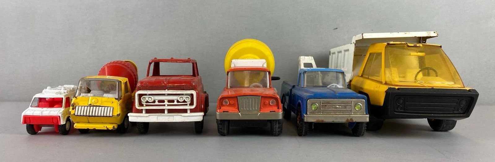 Group of 6 Pressed Steel Vehicles: Tonka cement truck has a crack windshield.Includes Structo Dump Truck, Japan Cement mixer, Tonka Cement Truck and moreLargest measures 4 3/4 x 3 1/2 x 10 1/4 inches