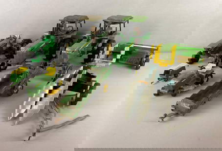 Group of 7 Metal John Deere Toys and More: Includes tractor, Corn Picker, manure Spreader and more. Largest measures 7 1/2 x 5 3/4 9 1/2 inches.