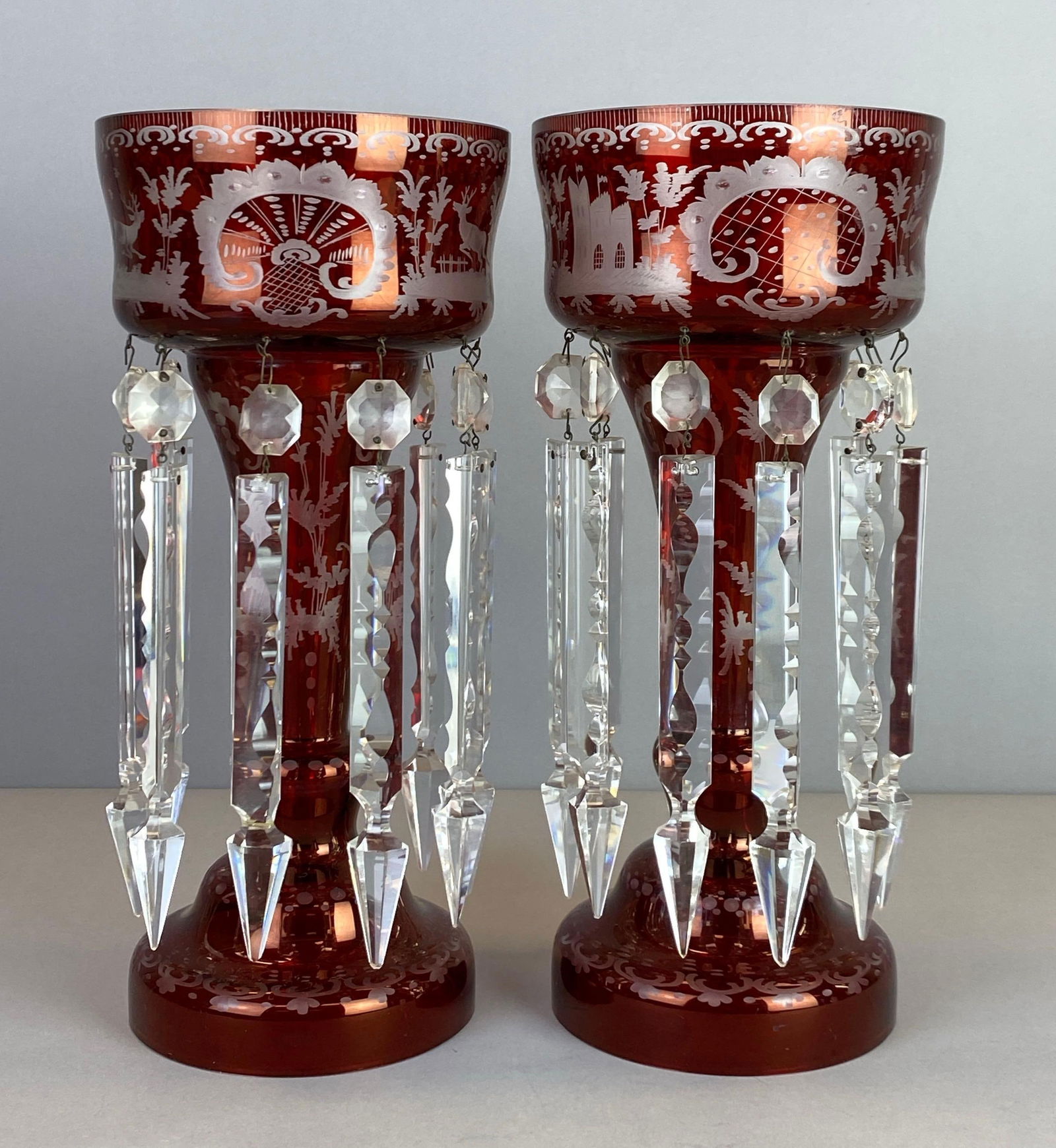 Pair of Egermann Bohemian Ruby Etched To Clear Glass Mantle Lusters: Features castle and Outdoors motif, Each measures 13 x 6 inches