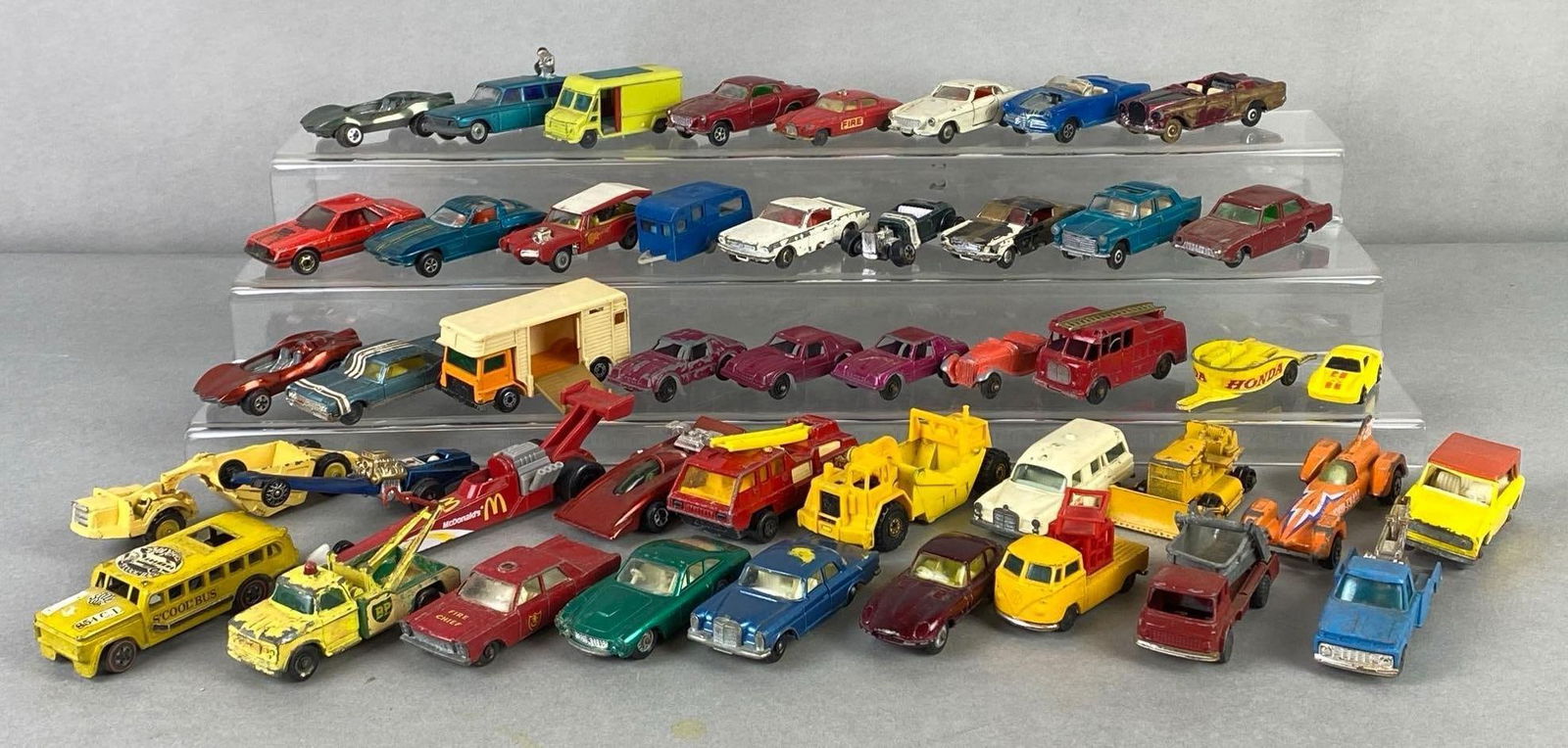 Group of 40+ Die-Cast Vehicles: With carrying case, Includes Corgi, Johnny Lightning, Hot Wheels, and more, Some tears and staining on case, Case measures 9 3/4 x 12 3/4 x 3 inches.