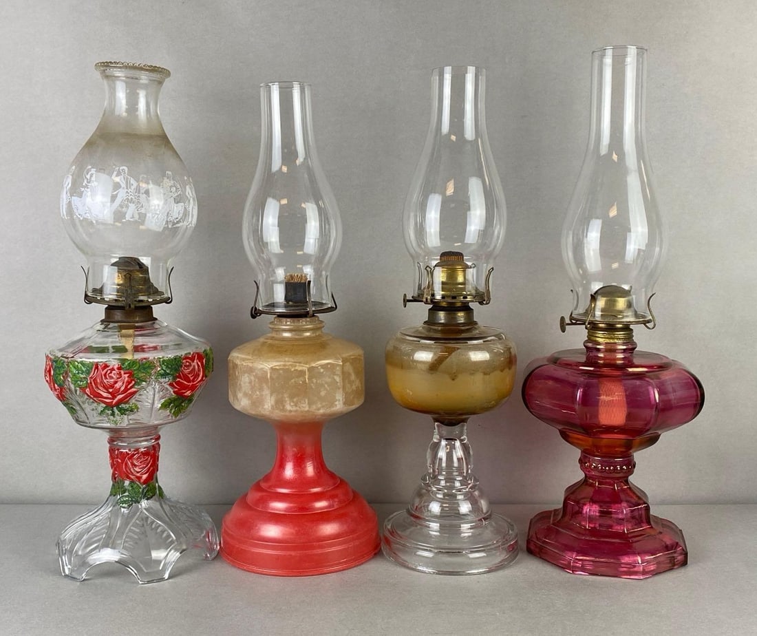 Group of 4 Glass Oil Lamps: Includes painted roses with dancer chimney, clear glass, cranberry glass, and other, Tallest measures 19 1/2 x 7 x 7 inches.