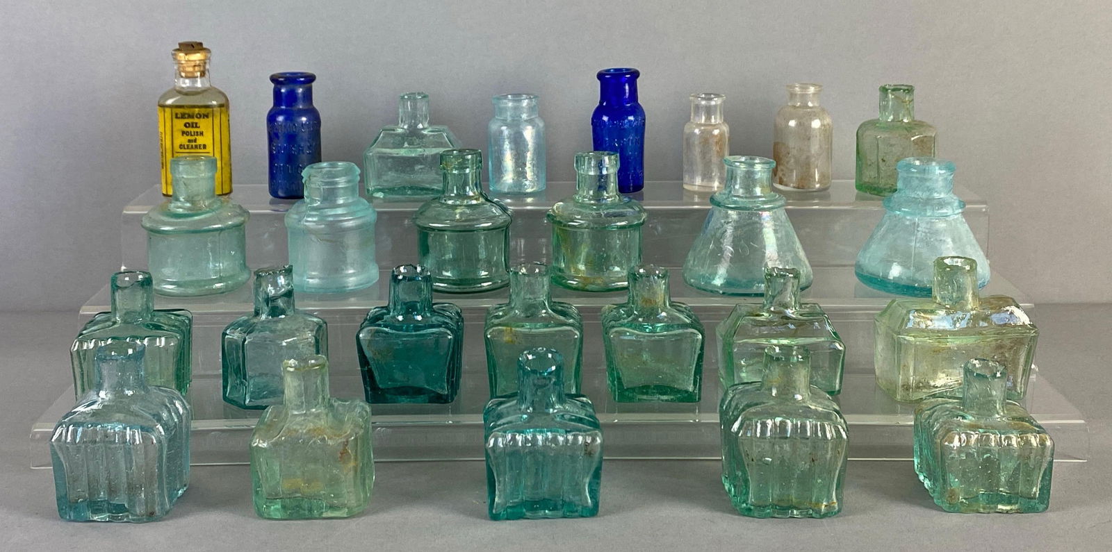 Group of Vintage Glass Inkwells and More: Includes Lemon Oil Polish, Apothecary jars and various styles of inkwells, chips throughout most rims, largest measures 2 3/4 x 2 1/2 inches