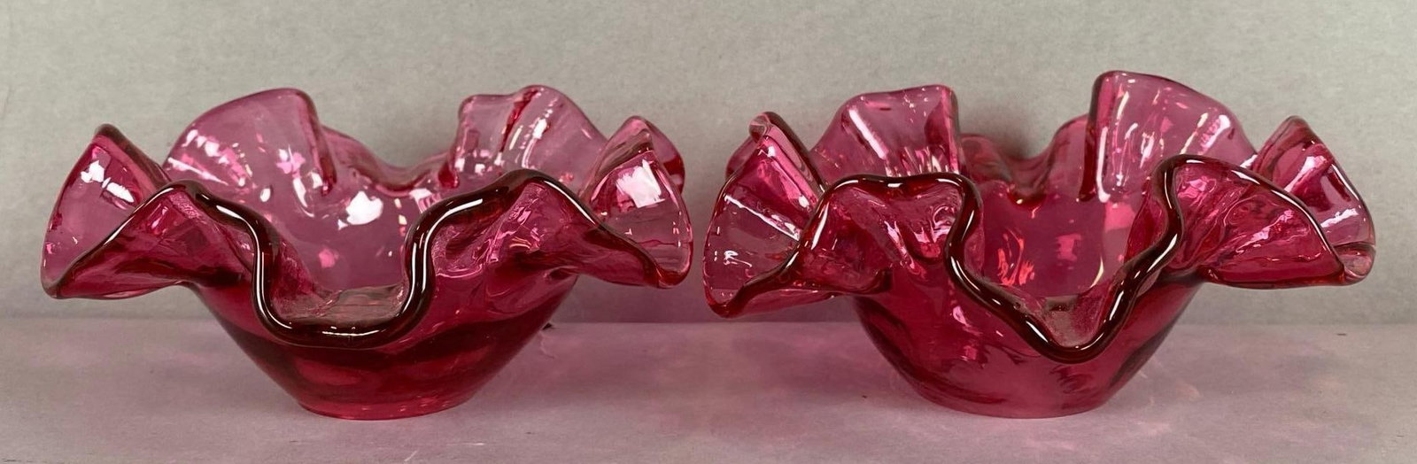 Group of 2 Antique Cranberry Glass Ruffled and Ribboned Bobeches: Largest measures 2 1/2 x 5 x 5 inches.