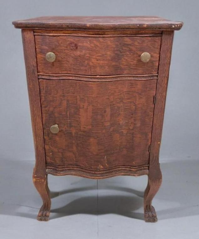 Antique Oak Serpentine Nightstand Cabinet with Drawer: No in-house shipping available, 3rd party shipper recommended. Paint overspray on top, claw feet, had been refinished, some dings and scratches. Measures 28 x 18 x 18 inches