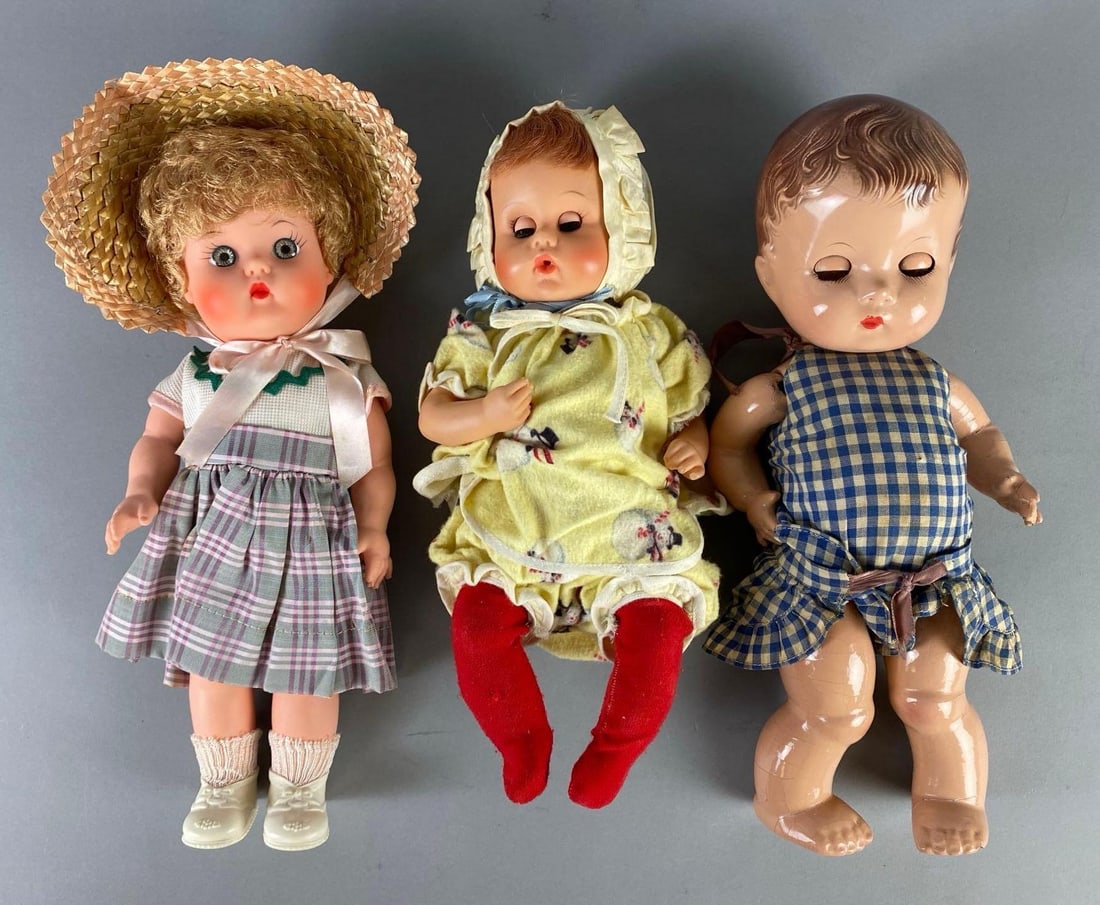 Group of 3 Baby Dolls: Includes Uneeda, A.M. Char, and Effanbee Candy Kid, Includes composite and vinyl, 2 with sleep eyes, Some crazing, Tallest measures 13 inches tall.