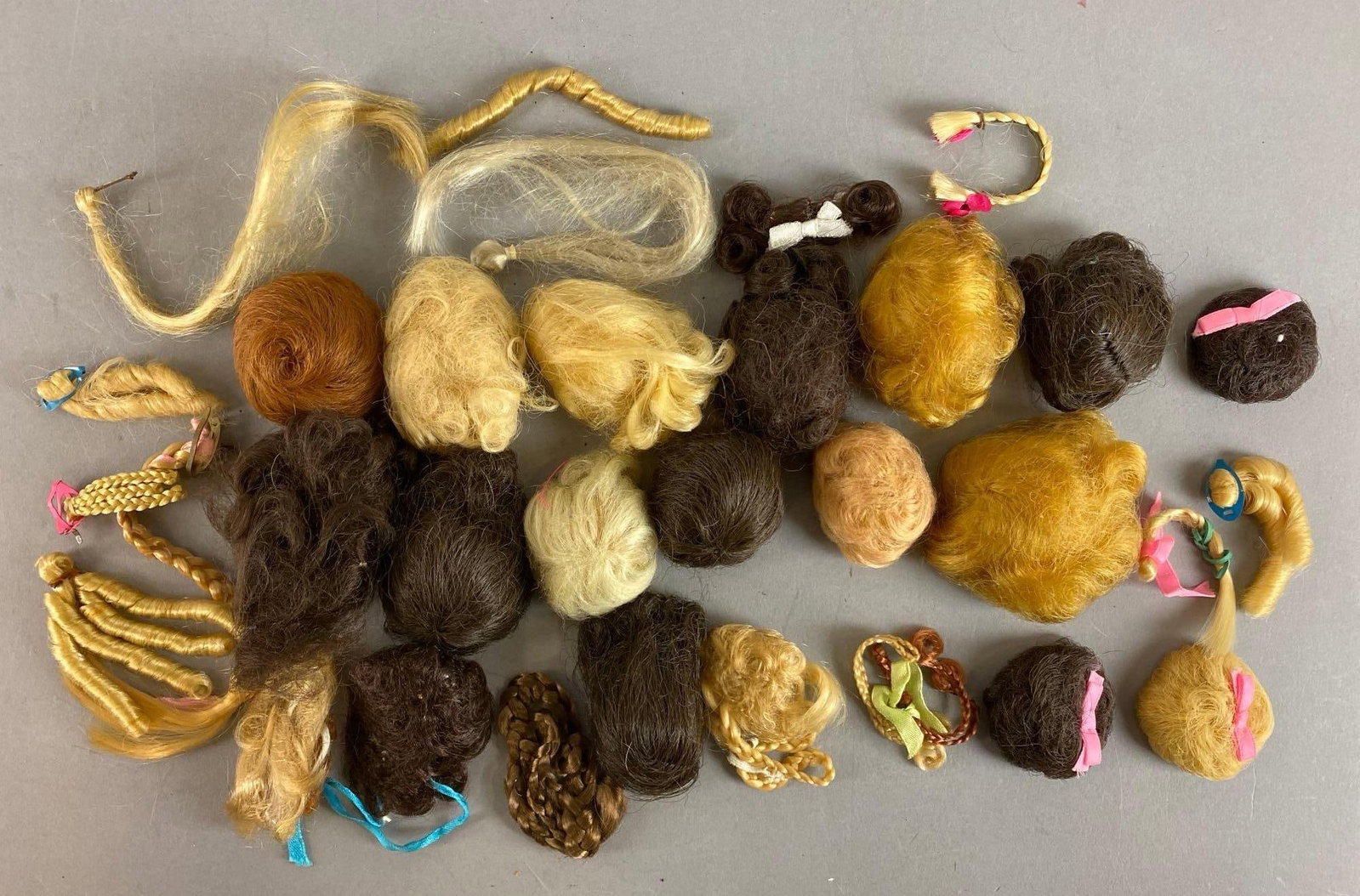 Group of 14 Mattel Bubble Cut Fashion Queen Barbie Wigs and more: 1963 Includes redhead, brunette blonde and more. Features headband, braids and curls.