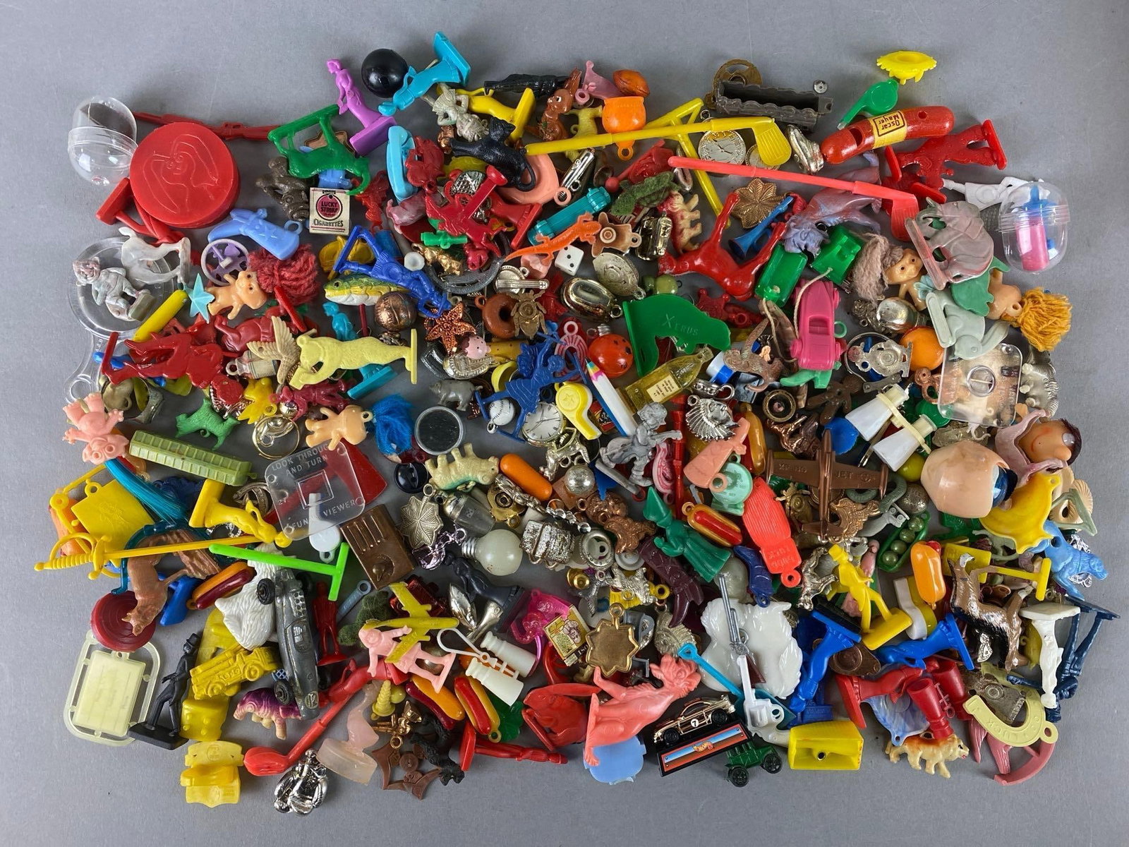 Group of Assorted Cracker Jack Toys and More: Includes treasure troll, mini binoculars, putter and more. Largest item measures 4 x 1/4 inches.