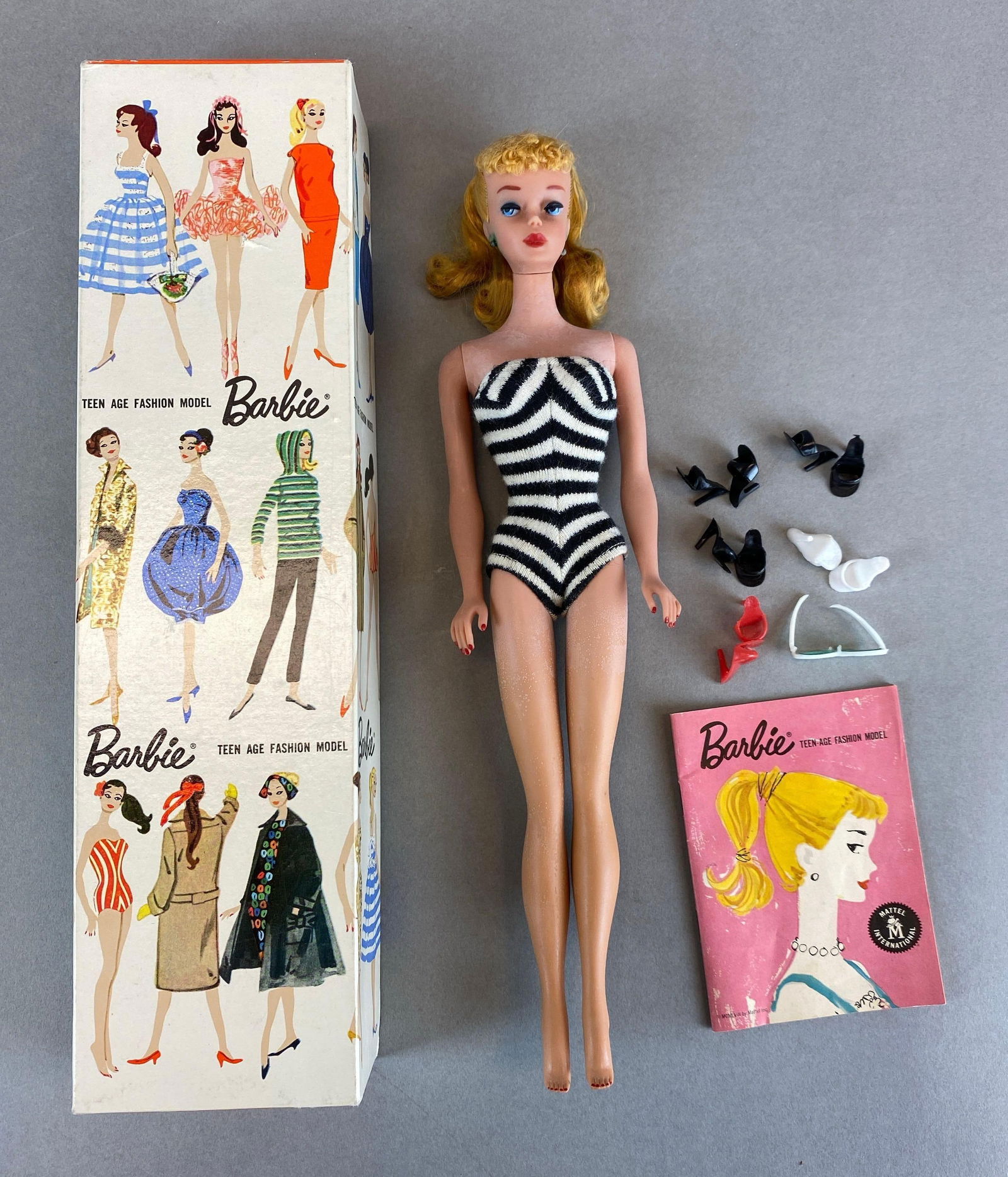 1958 Mattel Barbie Blonde Fashion Doll: Stock No. 850, made in Japan, corrosion on earrings and some discoloration throughout, doll measures 11 1/2 inches tall